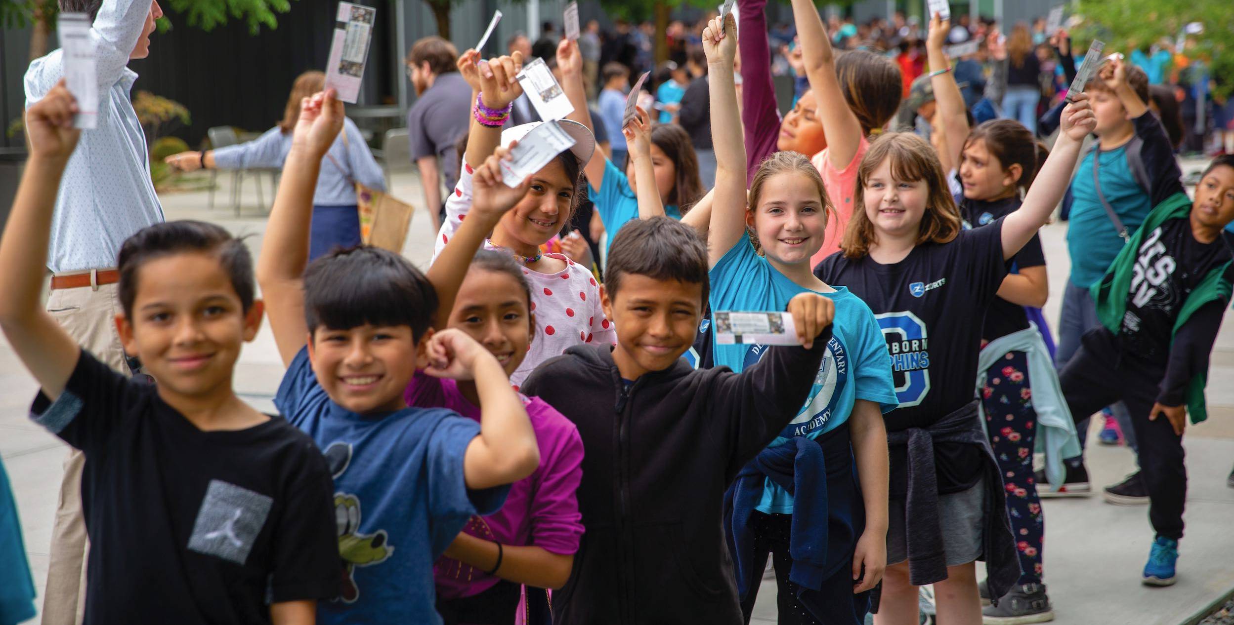 K-12-students-at-The-Soraya-holding-tickets-in-air-aspect-ratio-0-0